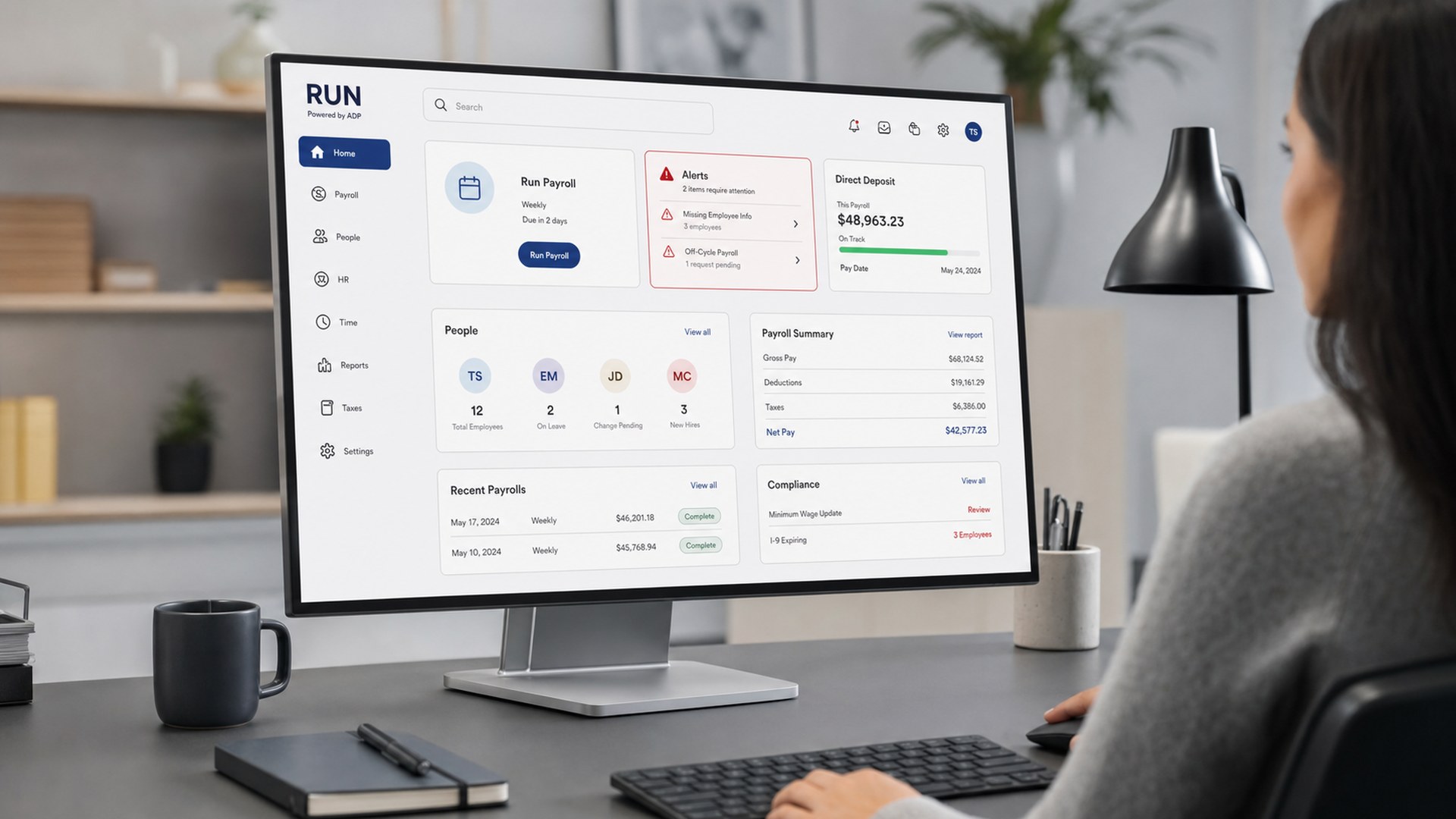 RUN Powered by ADP payroll dashboard on a desktop monitor